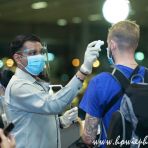 13 June 2020 Airport Staff takes temperature reading of transit passenger at Singapore Changi Airport