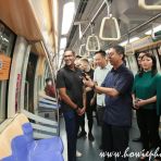 23 Sept 2023 MOS Dr Muhammad Faishal Ibrahim scans QR code on the visual of the LTA SANA themed train as the featured talent looks on